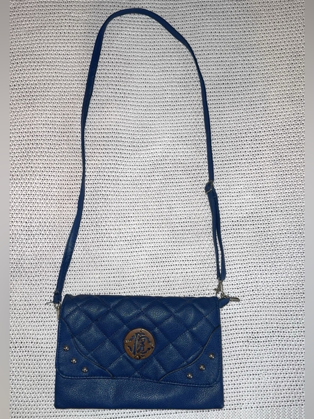 Quilted Blue Crossbody Bag with Gold Medallion Accent
